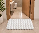 Warm Modern Bathroom with Plush White Rug.webp